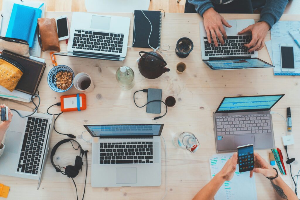 Many laptops of remote workers on a table