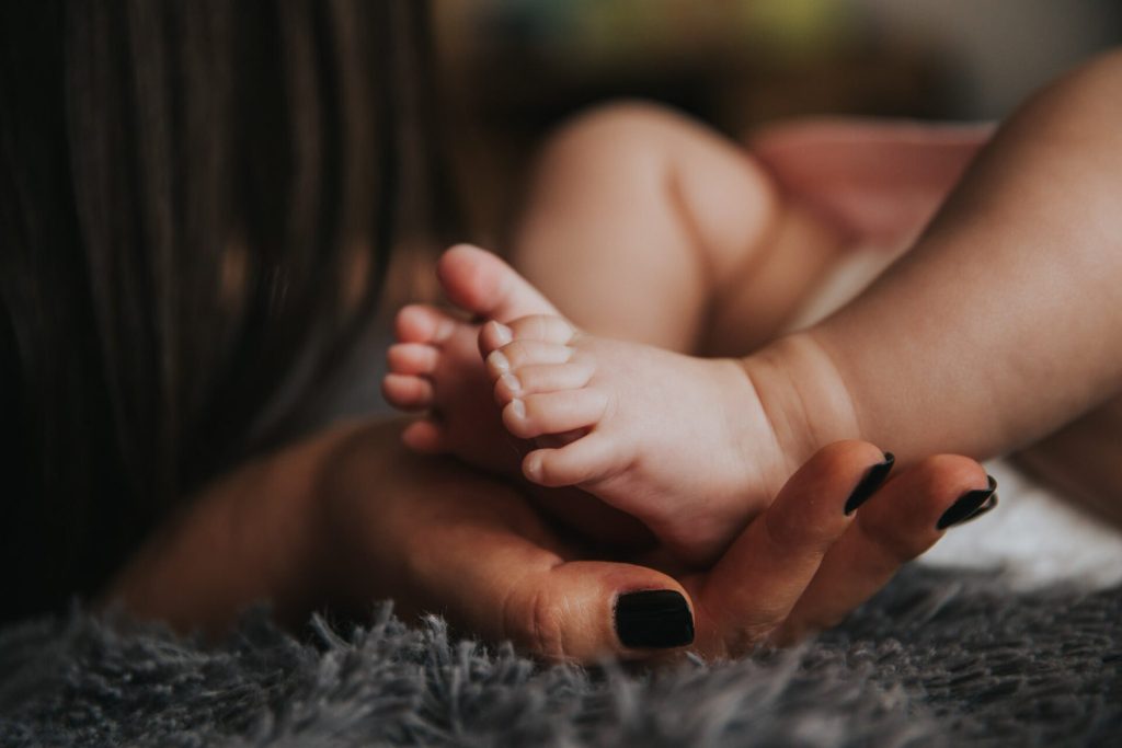 Mum holding baby feet, nanny in Thailand, Indonesia and Vietnam