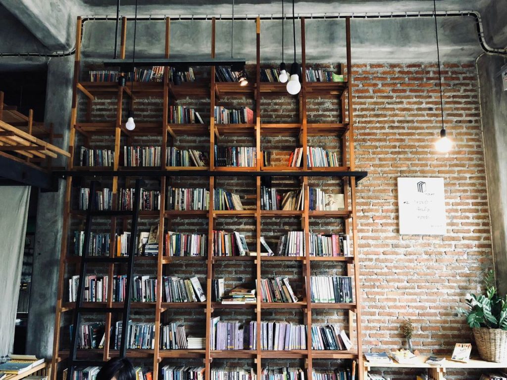 A large wall full of books in a cafe in Chiang Mai