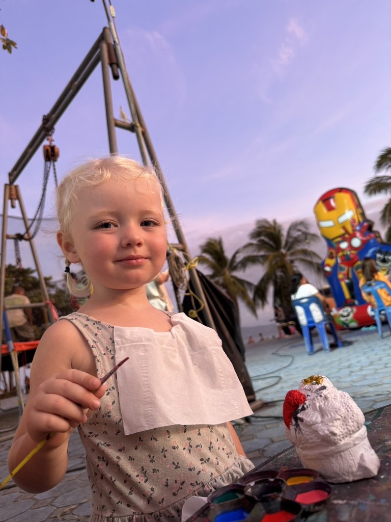 Little girl painting a figure