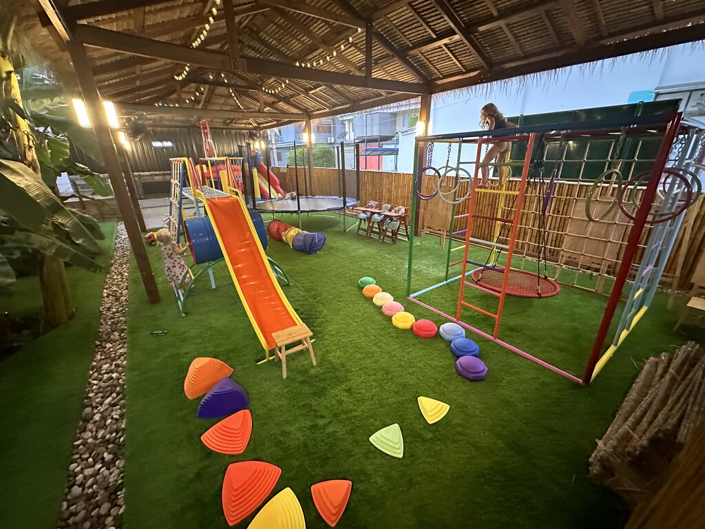 playground with ball pit, climbing fence and slide