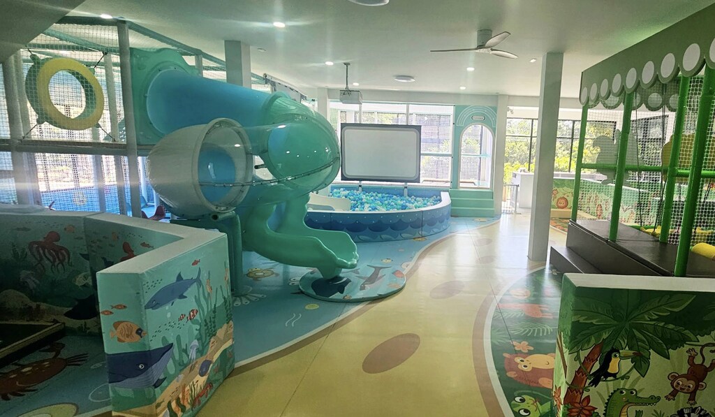 Indoor playground with huge slide and VR screen.