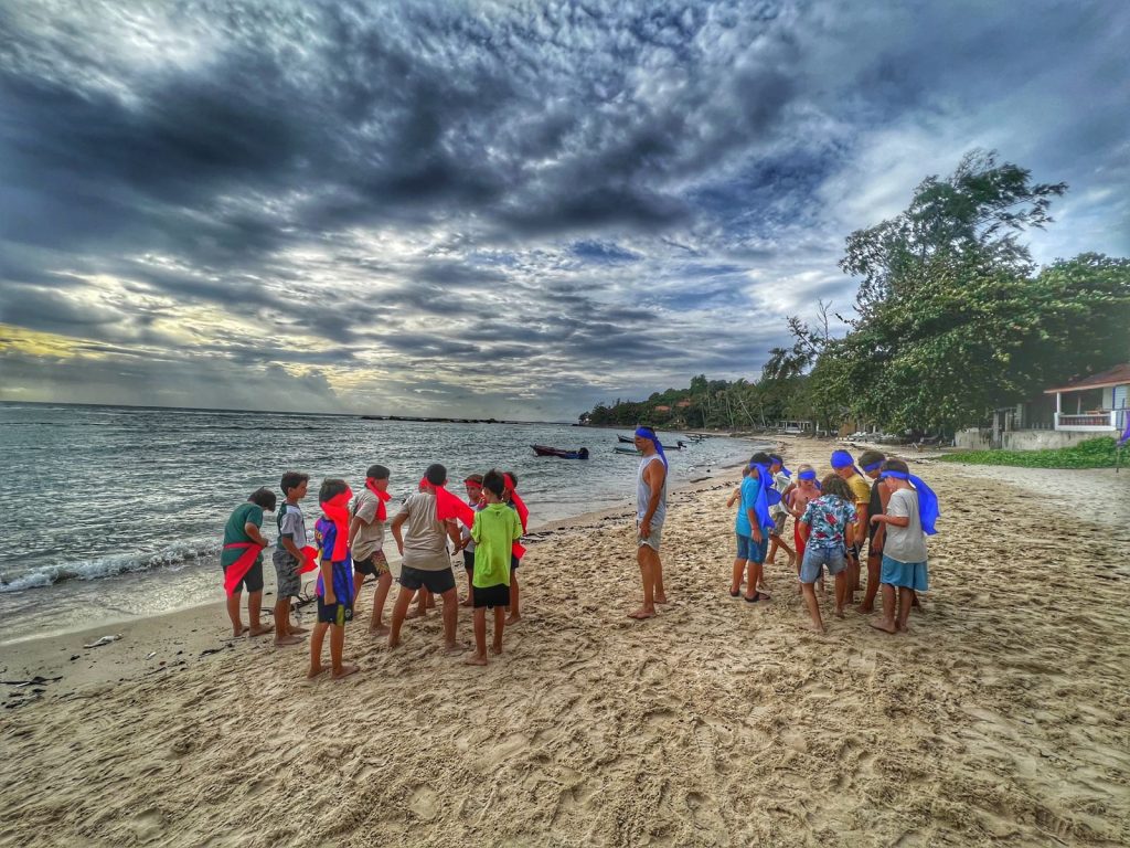 Best things to do in Koh Phangan: Tropiquest, Group of kids playing at a beach in Koh Phangan, Thailand