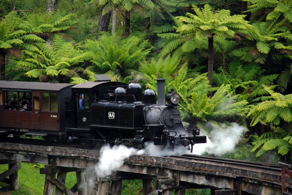 Railway in front of green background.