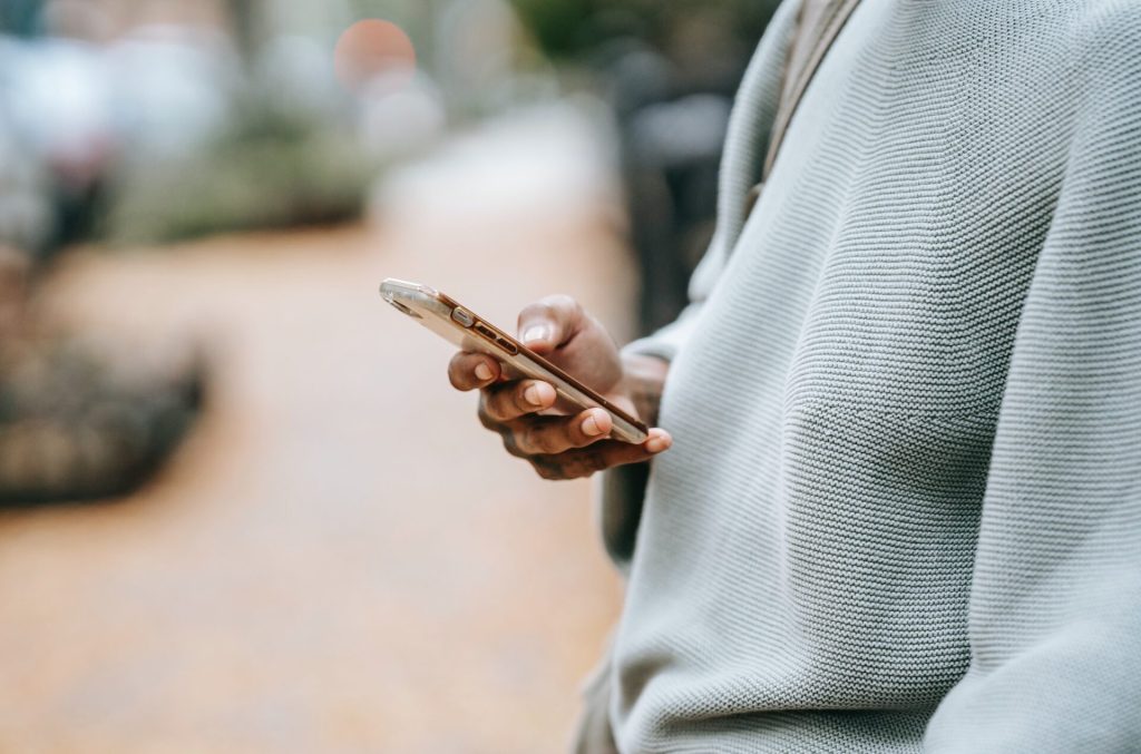 Black woman using travel Apps, travel app on her phone.