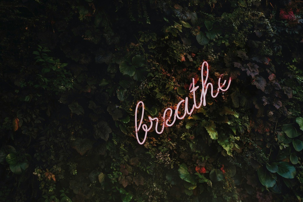 Neon sign that says "breath", steps to minimalism