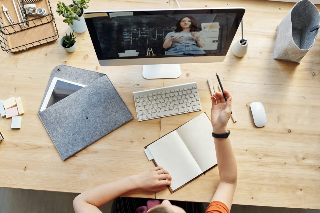 A work desk from above with a women skyping with another woman.