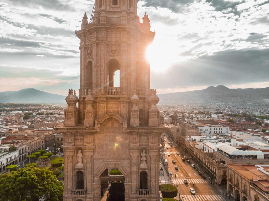 Morelia, Mexico, big church in front, city with mountains in the background