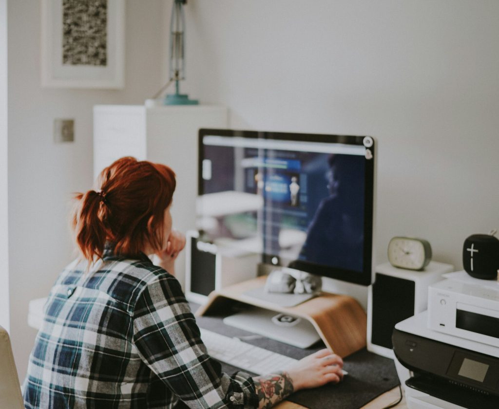 Woman working on a mac, view from behind