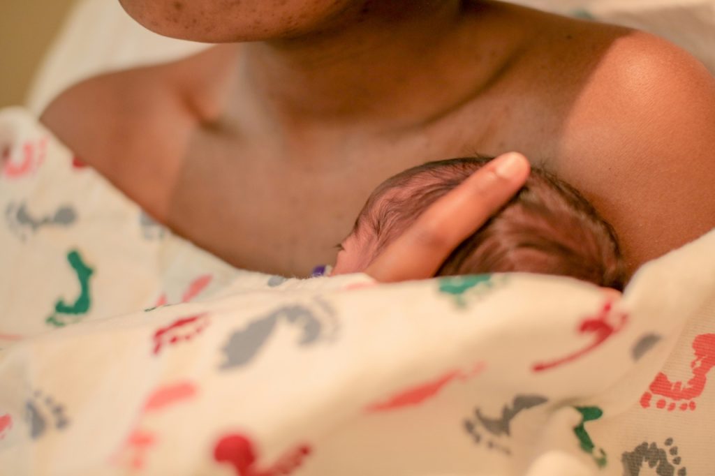 Mum holding her newborn on her chest, natural delivery is on of the most common baby delivery options