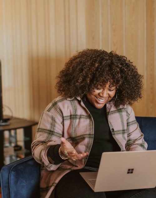 Woman sitting on the laptop and having a zoom meeting