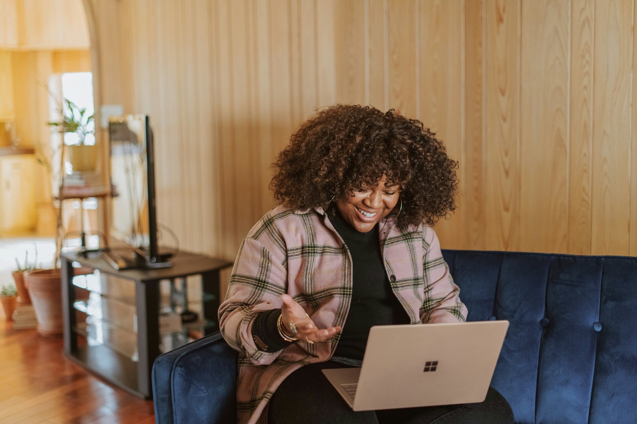 Woman sitting on the laptop and having a zoom meeting