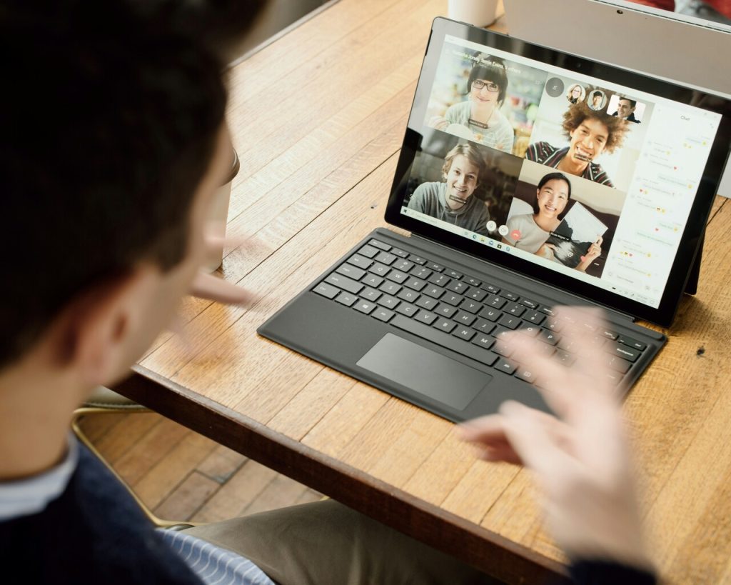 Man working on laptop having a zoom call 