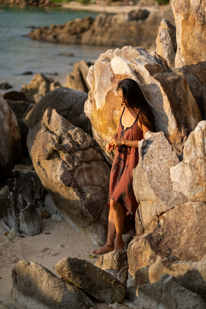 a woman standing next to rocks