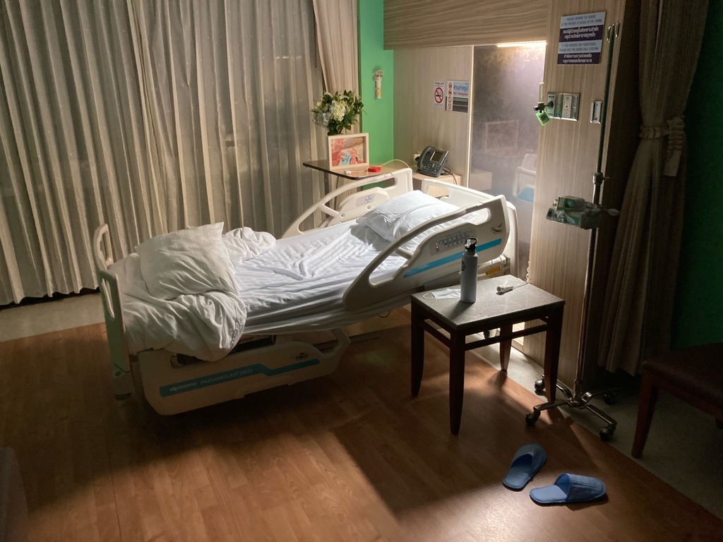 Hospital bed in room with green walls