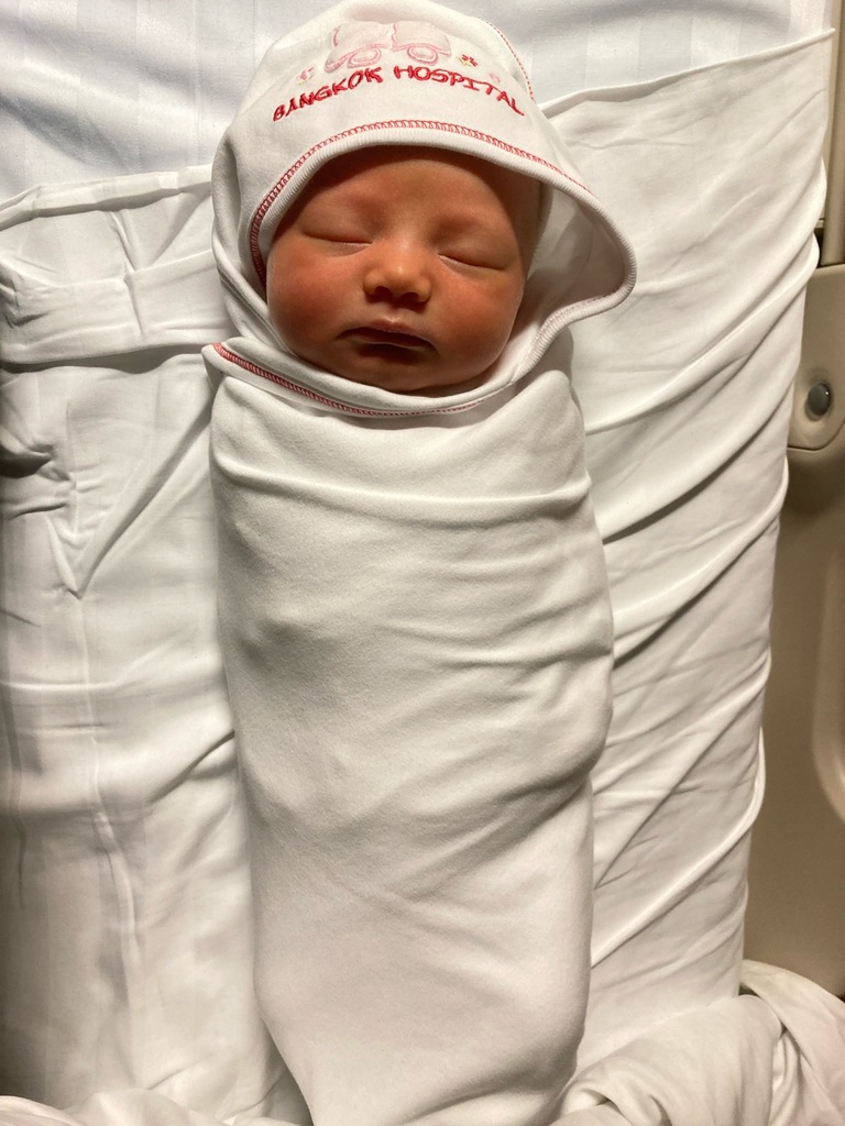 Newborn wrapped in white blanket