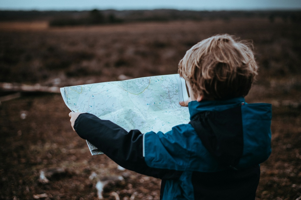 little boy looking at a map trying to orientate, traveling full time with the family