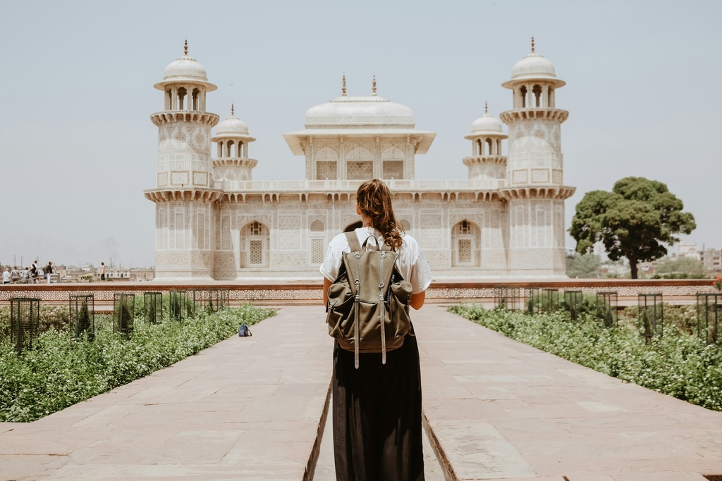 woman walking towards a popular landmark, view from behind