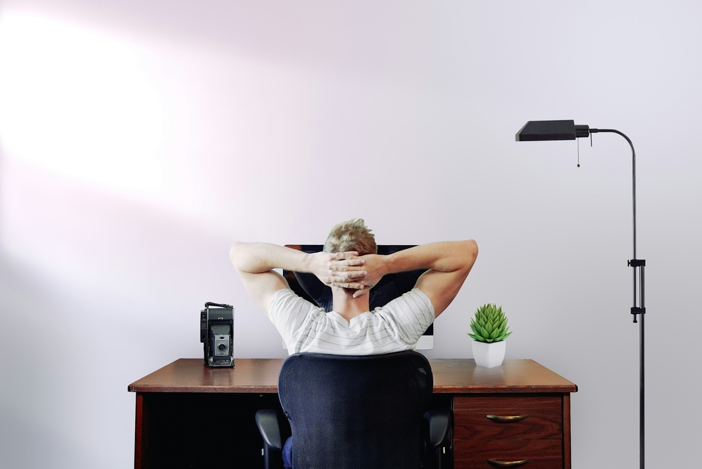 man siting on working table, view from behind, How to travel around the world and make money