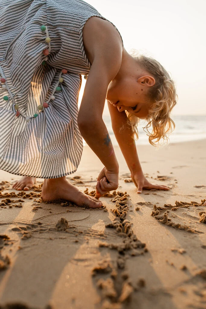 Young girl playing on the beach.