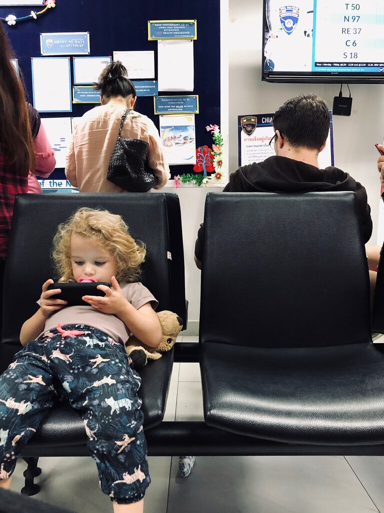 Toddler girl watching cartoons on smartphone