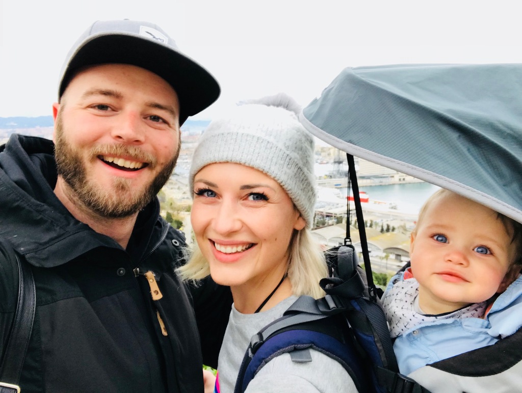 Family of three with baby in the carrier, full-time family travel