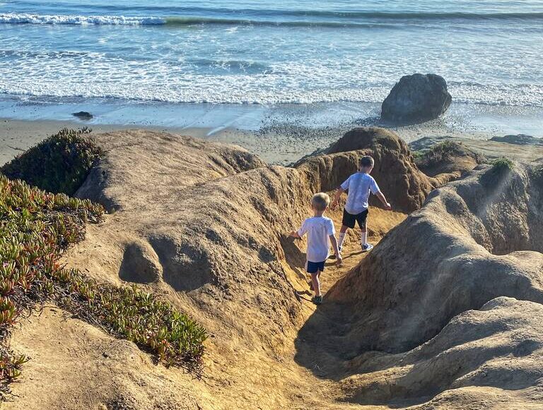 Two boys running on a coast line