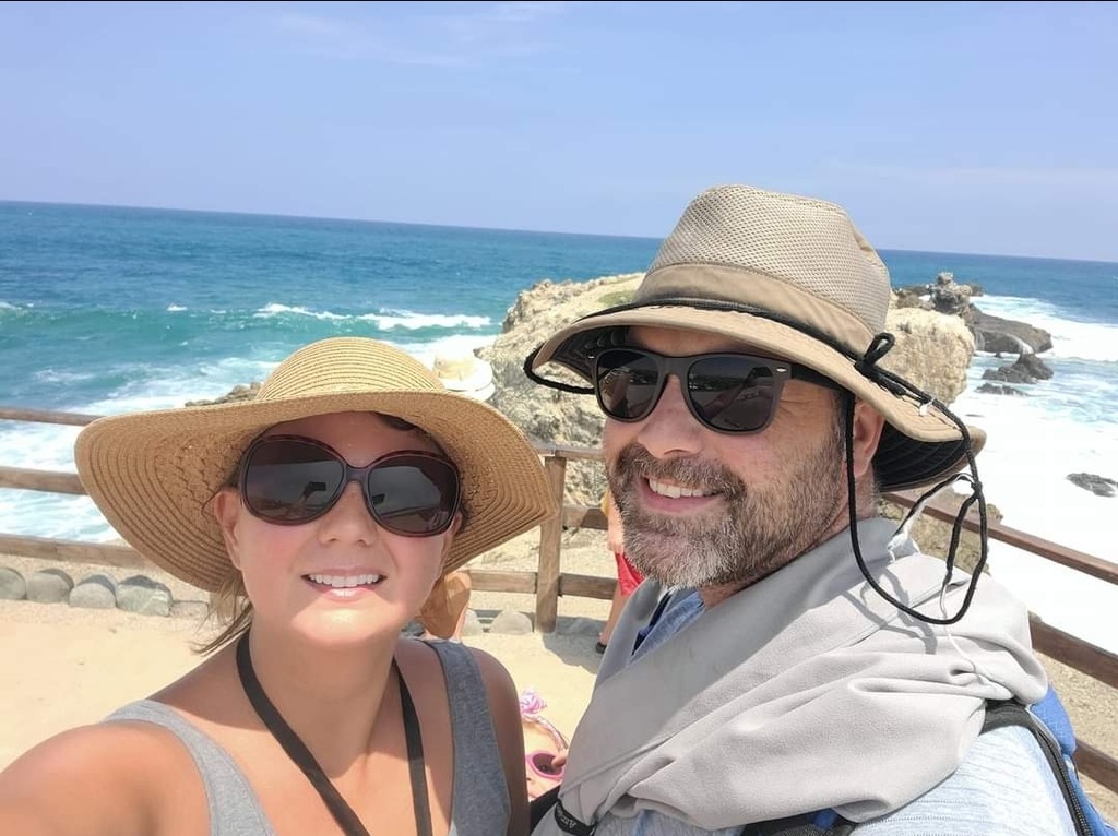 Husband and wife making a selfie at a beach