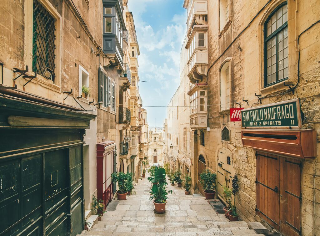 old city street with beige houses left and right, malta nomad visa tax