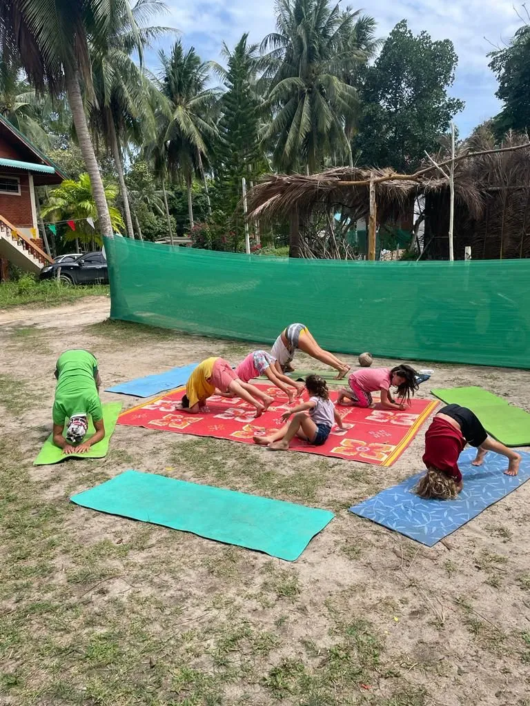 Kids practicing yoga in a garden