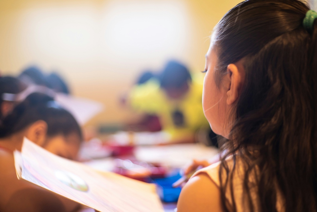 Young girl studying with a book