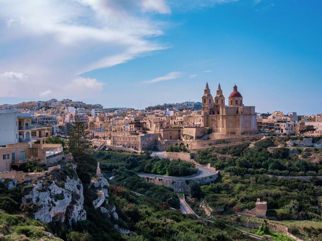 birds view on old european city with hthree high towers and surrounding green