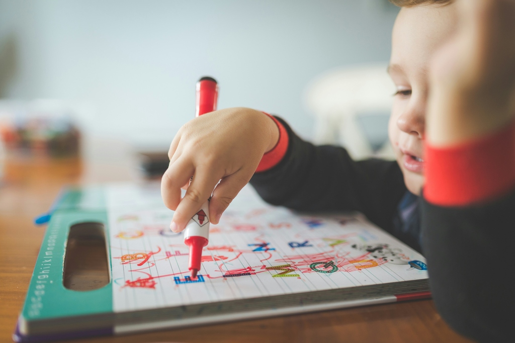 Young boy drawing on a paper