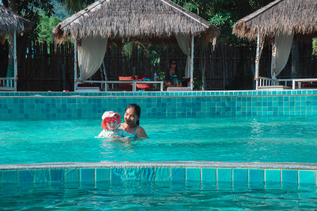 Thai Nanny and baby in a large pool