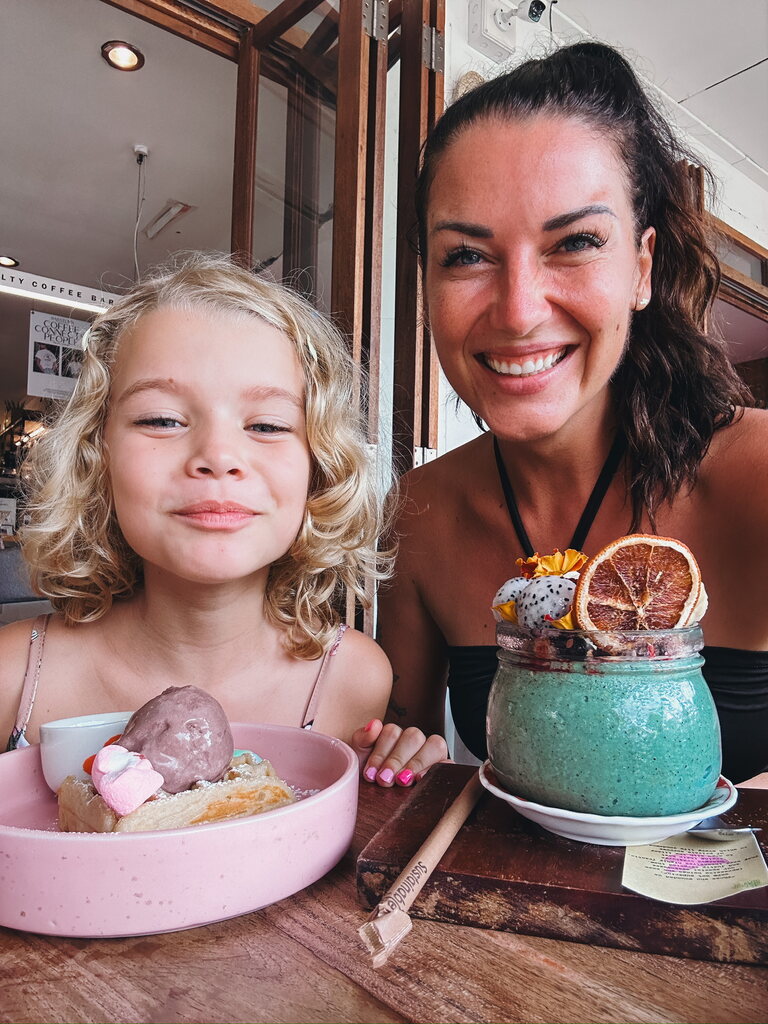 Mother and daughter eating sweets in a restaurant