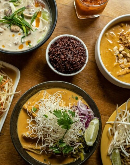 Thai dishes and curries on a wooden table