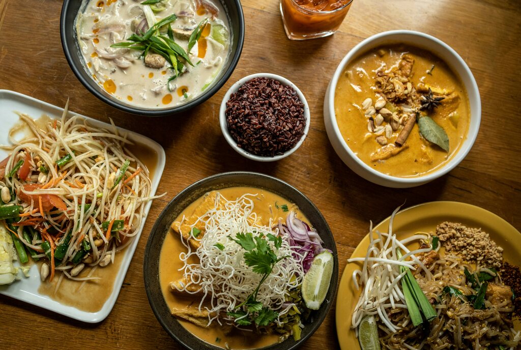 Thai dishes and curries on a wooden table