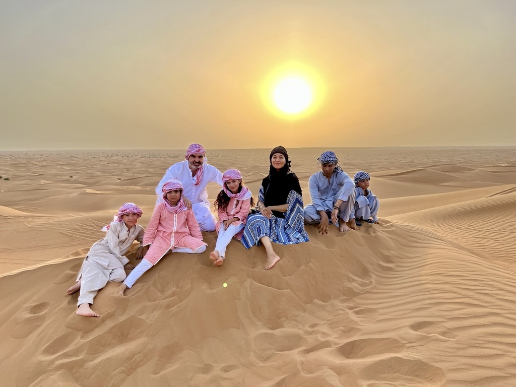 Family of 7 sitting in the desert