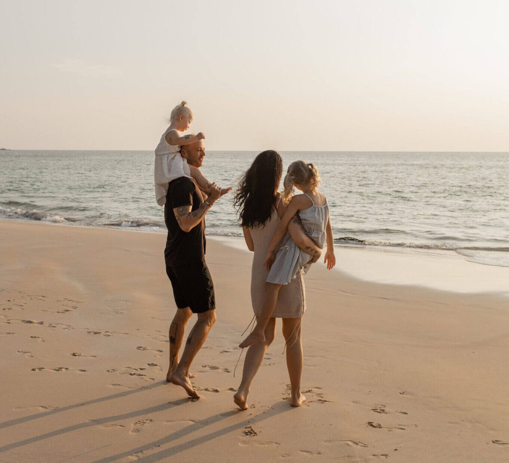 A family walking towards the sea.