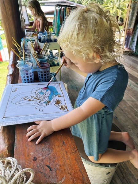 Little girl drawing on a cotton sheet