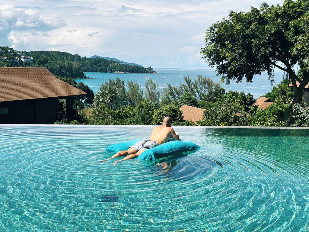 Man floating in infinity pool