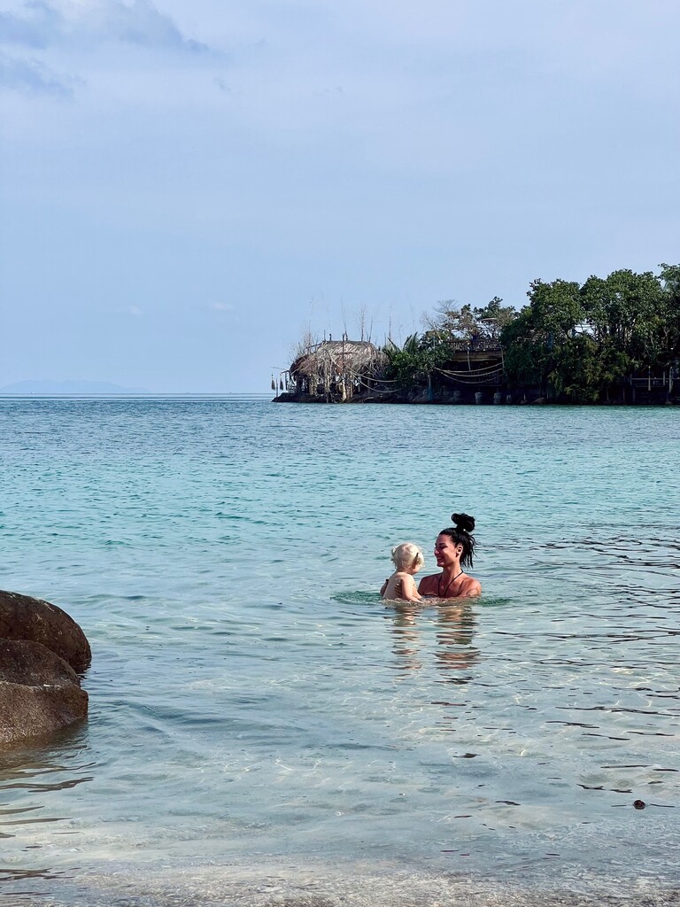 Mum and young daughter swimming in the ocean