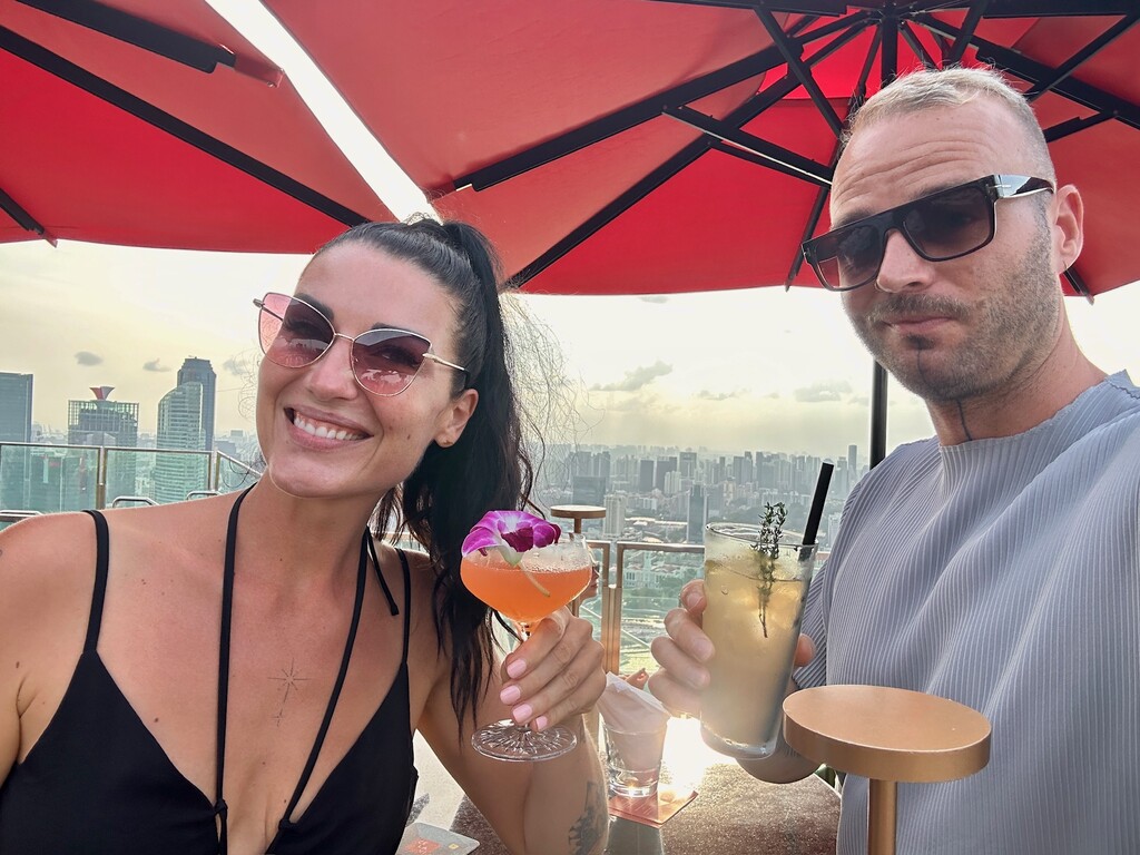 Couple enjoying cocktails at a rooftop bar