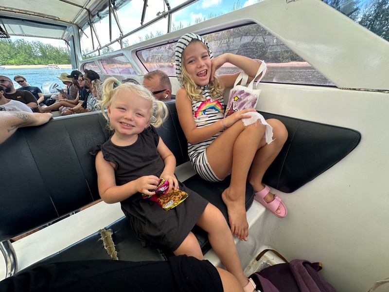 Two young girls sitting in the front row of a speedboat, things to do in koh yao yai with kids