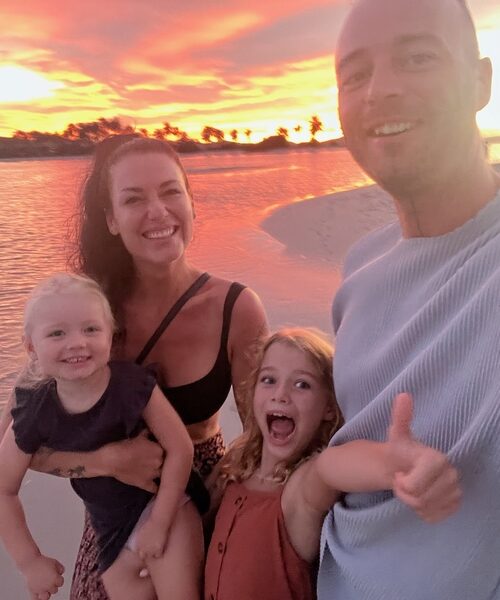 Family on the beach during sunset