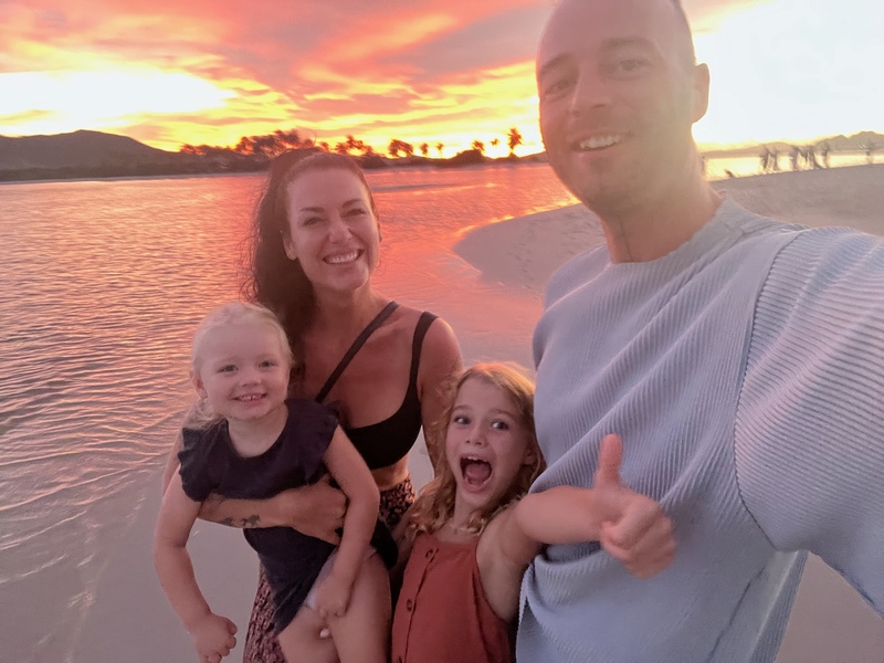 Family on the beach during sunset