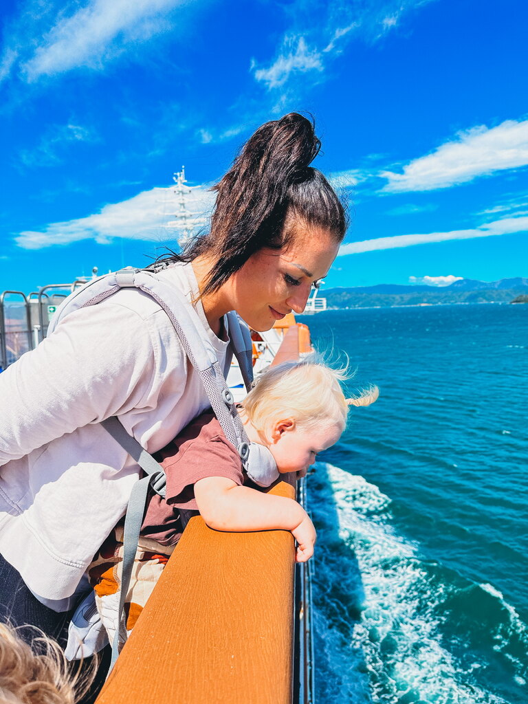 Mum and toddler looking at the sea on a ferry trip in New Zealand, Travel with Toddler Checklist