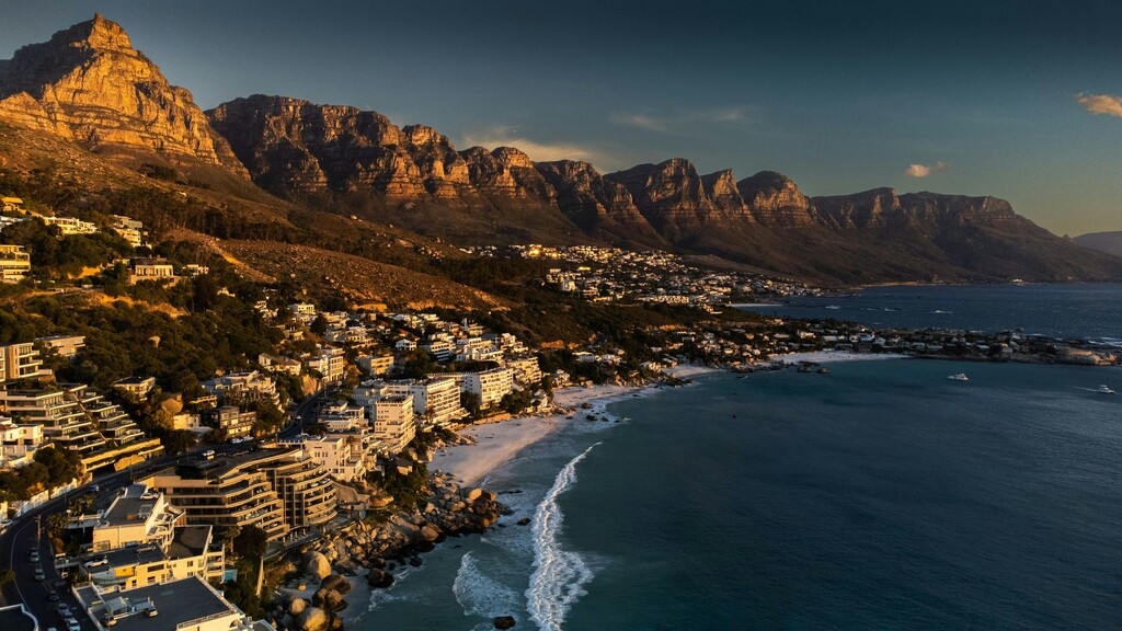 Mountain with city and sea in front