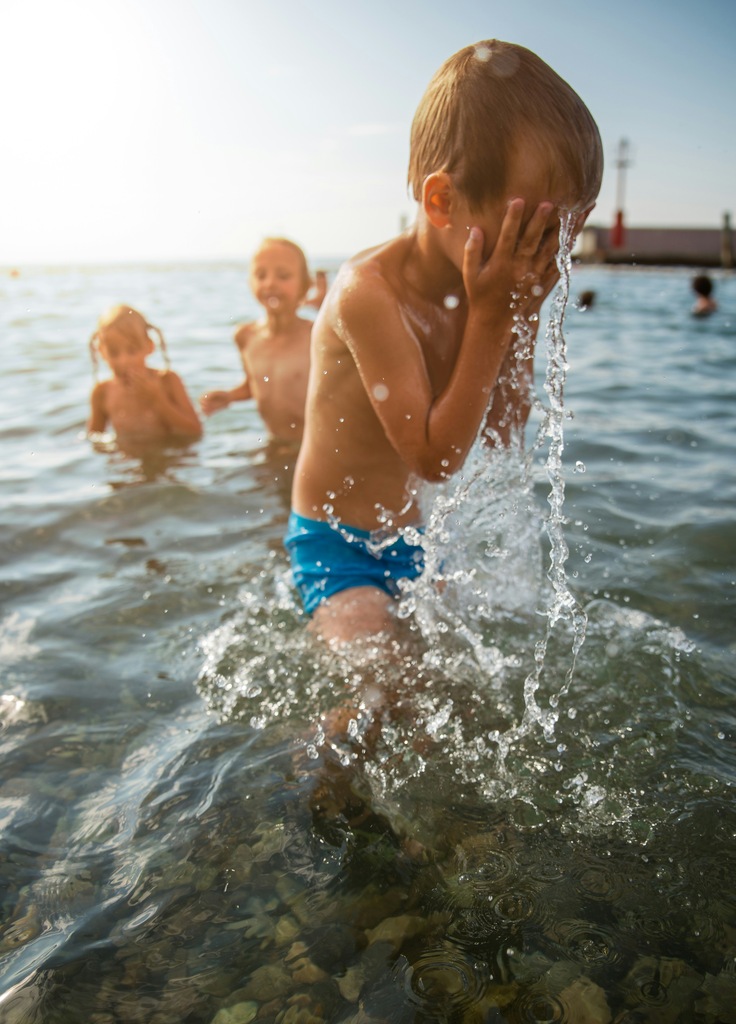 Three young kids playing in the sea