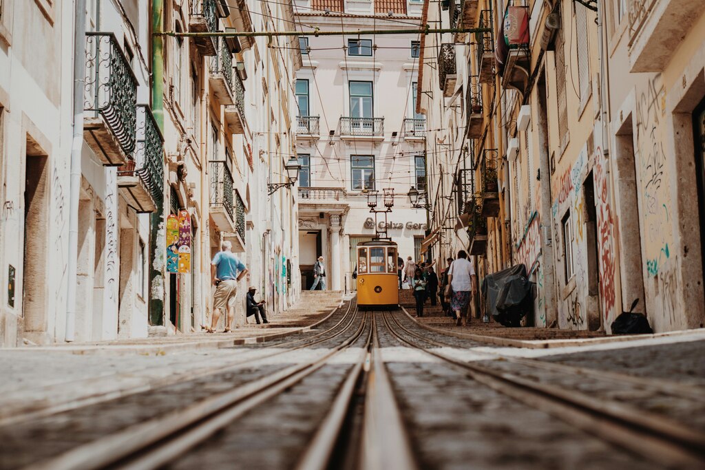 beige buldings with a yellow tram in between